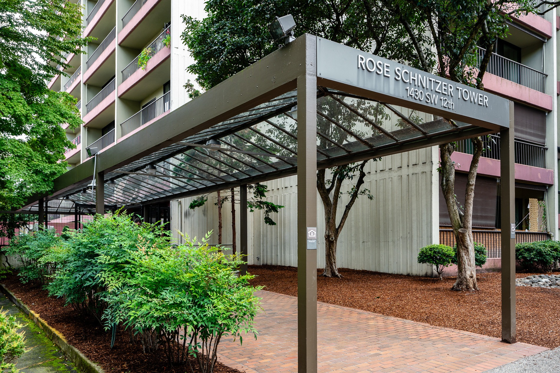 an exterior view of the rosemary tower condominiums in front of a building